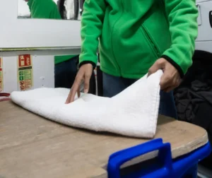 commercial laundry towels being folded in laundry facility